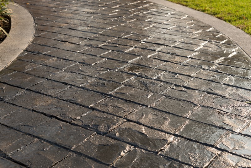 black stamped concrete walkway grey border