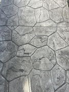 Gray stamped concrete surface with irregular stone pattern and textured finish