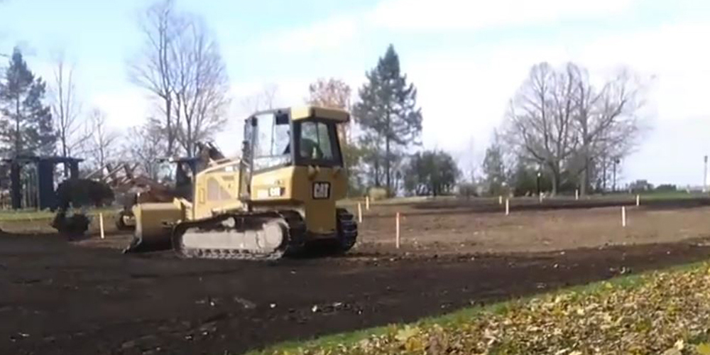 bulldozer grading a field for sod Installation