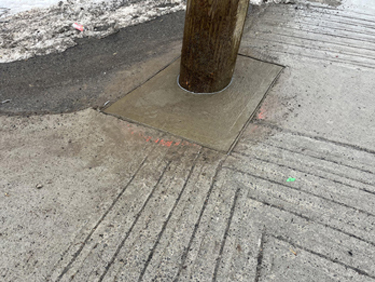 concrete sidewalk patch repair around hydro pole