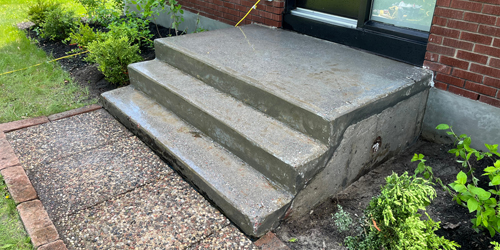 pouring concrete into forms in front yard