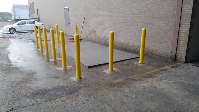 Fuel tank slab with bollards