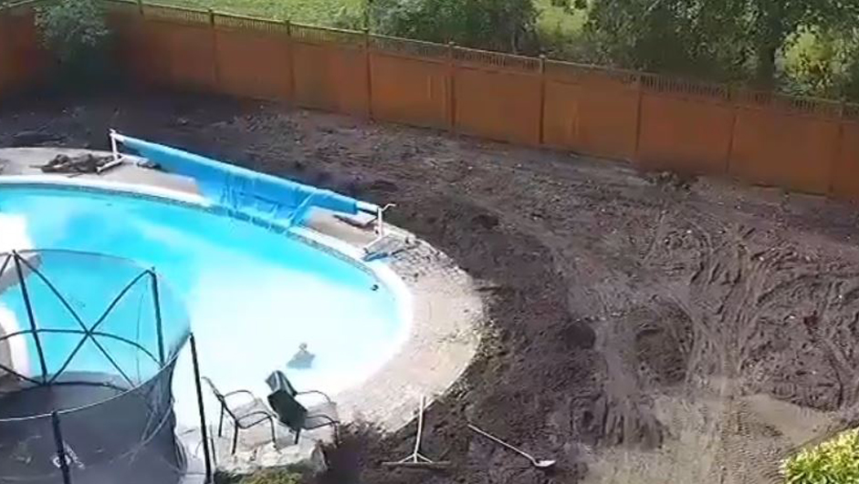 back yard with pool soil spread aroud lawn