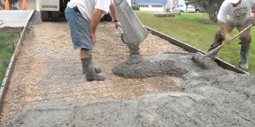 pouring concrete into forms in front yard