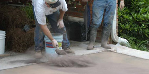 spreading concrete release powder on slab