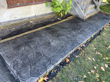 grey stamped concrete walkway with random stone stamp
