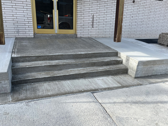 broom finished concrete step and entryway