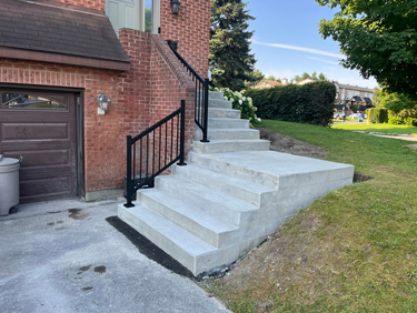 broom finished concrete steps with landing and railing